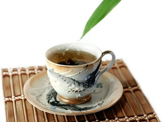 a cup of tea and drops isolated on white background