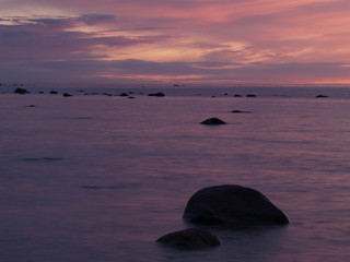 Fototapeta na wymiar Rocks in sea at dusk