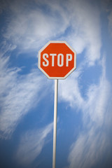 Traffic stop sign against a sky