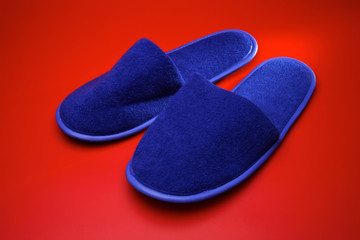 Blue slippers on red background