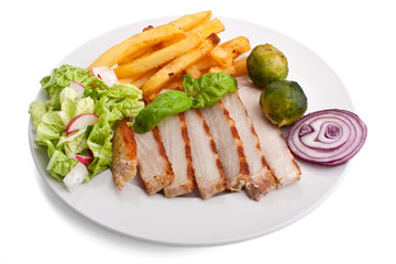 sliced pork chops with fries and brussels sprouts