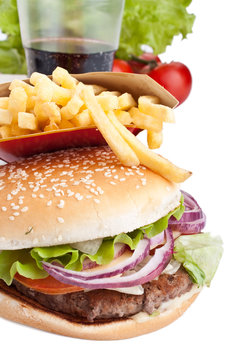 cheeseburger, french fries and cola on white background