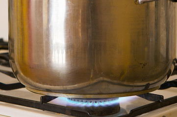 Photo of a pot on the flames of kitchen
