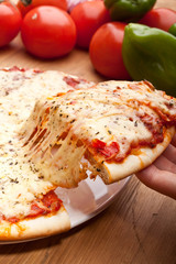 Slice of pizza margarita lifted up