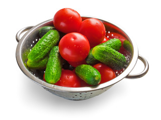 Cucumbers and tomatoes in steel bowl