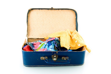 Blue suitcase with clothes on white background