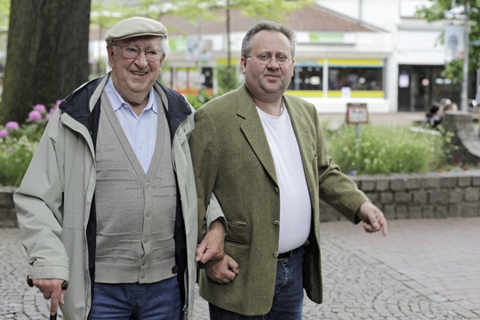 Grandpa and grandchild going through the city