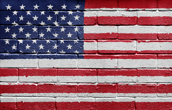 Flag of the USA painted onto a grunge brick wall
