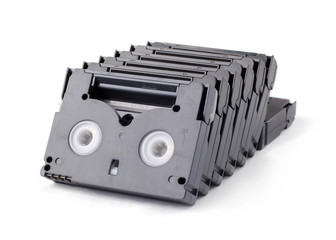 A few old Hi-8 video tapes stack inline with white bakground