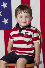 Little boy on chair with flag