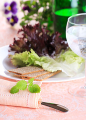 Fresh green salad with glass of water