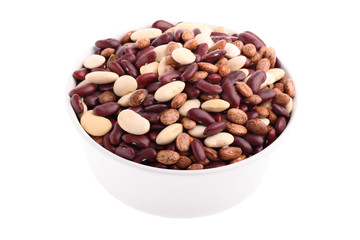 Various bean types in white bowl isolated on white