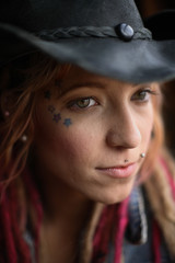 Portrait of young woman with Dreadlocks in hair