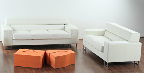 A modern minimalist living-room with white furniture