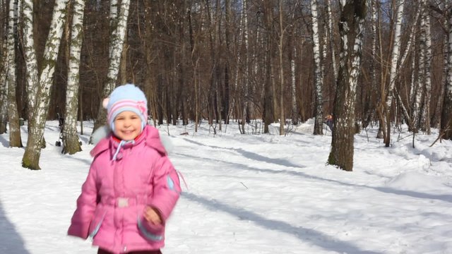 Small girl runs in wood