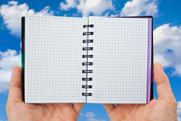 spiral notebook in hands