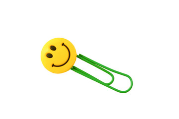 Green paper clip with a smile isolated on a white background