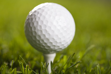 Golf ball on tee in grass