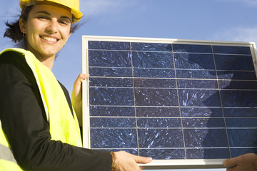 Young woman with a small solar panel