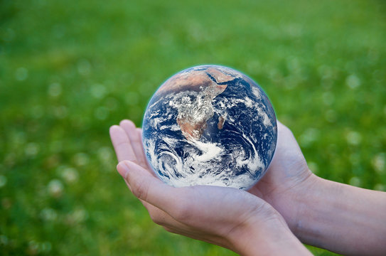 Hand holding a globe. Save Earth Environment