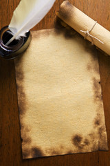 Old paper, quill pen and scrool on wooden paper