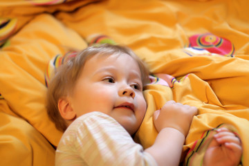 The little boy goes to sleep at home