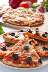 different sliced pizzas with ingredients