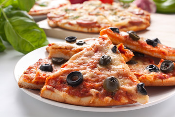 different sliced pizzas with ingredients