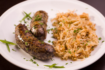 Two grilled bavarian sausage with cabbage