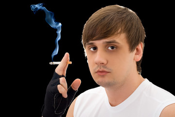 Fototapeta premium Portrait of the young man with a cigarette. Isolated
