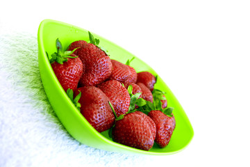 fresh strawberry in a green plastic dish