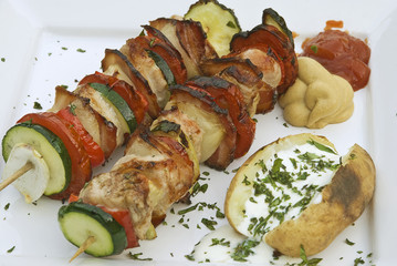 Barbecue spits with baked potato