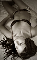 Attractive Brunette in Underwear on her Bed