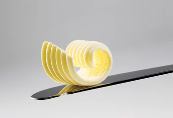 Gordijnen Butter curl on a knife © Viktor