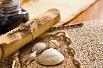 Old journal book, scroll and quill pen on wooden table