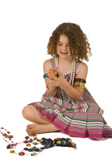 Adorable little girl playing in the studio with jewelery.