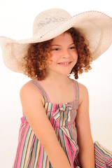 Adorable little girl wearing a hat in the studio.