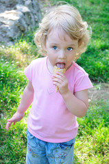 little girl outdoors eating huge ice cream cone