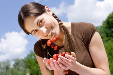 portrait of the happy girl with cherry