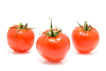 three red tomatoes isolated on white background