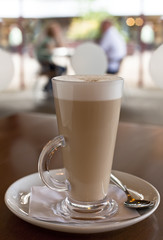 coffee latte in tall glass on cafe background