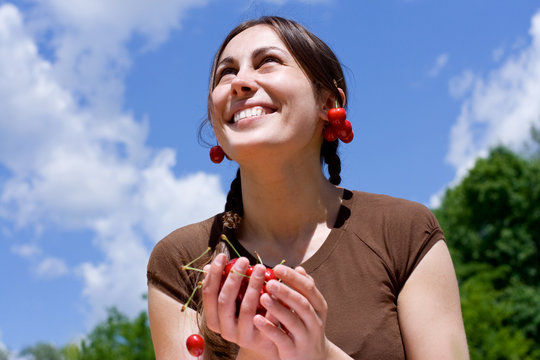 portrait of the happy gilr with cherry