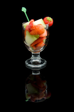 Fruit cocktail isolated on black background
