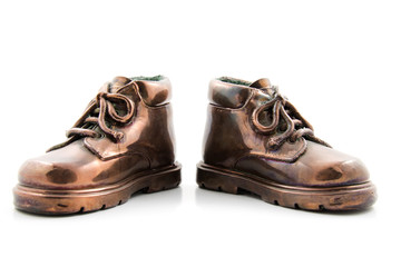 pair of bronze kids shoes isolated on white background