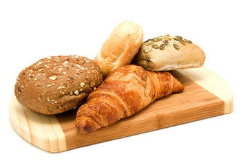 Bread on wooden board isolated on white background