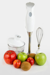 Blender with different ripe fruits