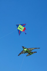 Two kites against a blue sky