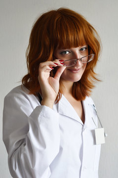 Female doctor confidently looking over glasses