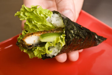 cook on a kitchen prepares Japanese susi