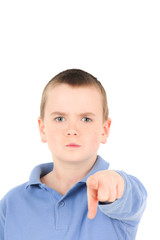 Portrait of young boy pointing finger, studio shot